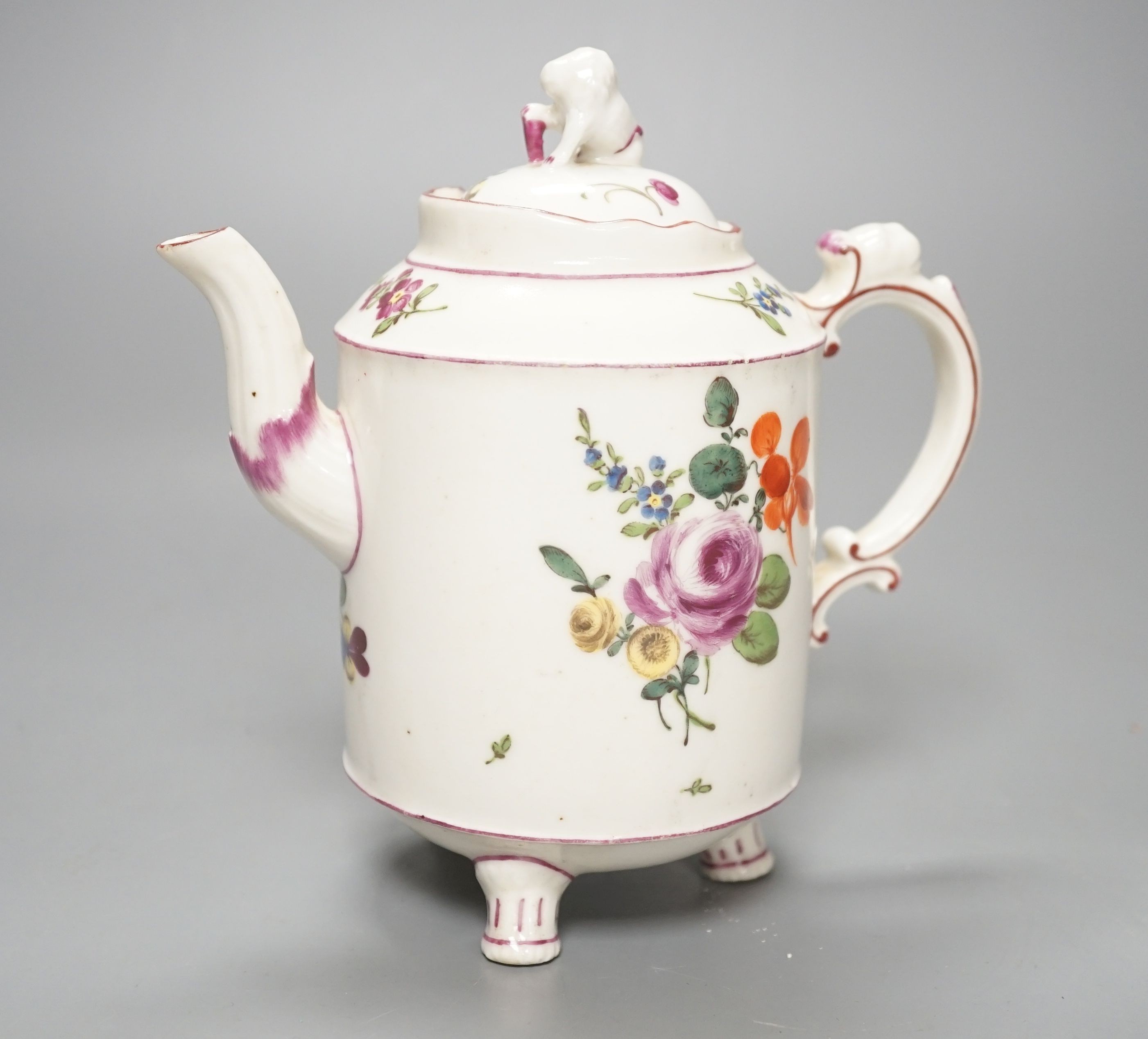 An 18th century Ludwigsburg three footed teapot and cover with lion finial and lion head on handle painted with flowers, height overall 16.5cm